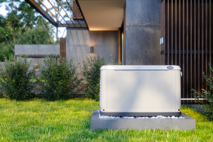Outdoor generator installed in the garden of a contemporary home.